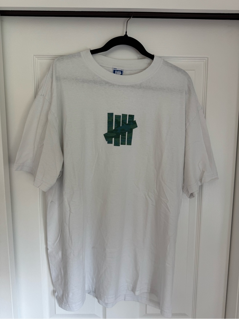 Undefeated White Short Sleeve Tee with Army Green Logo